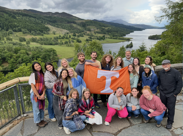 Students smiling with Tennessee flag